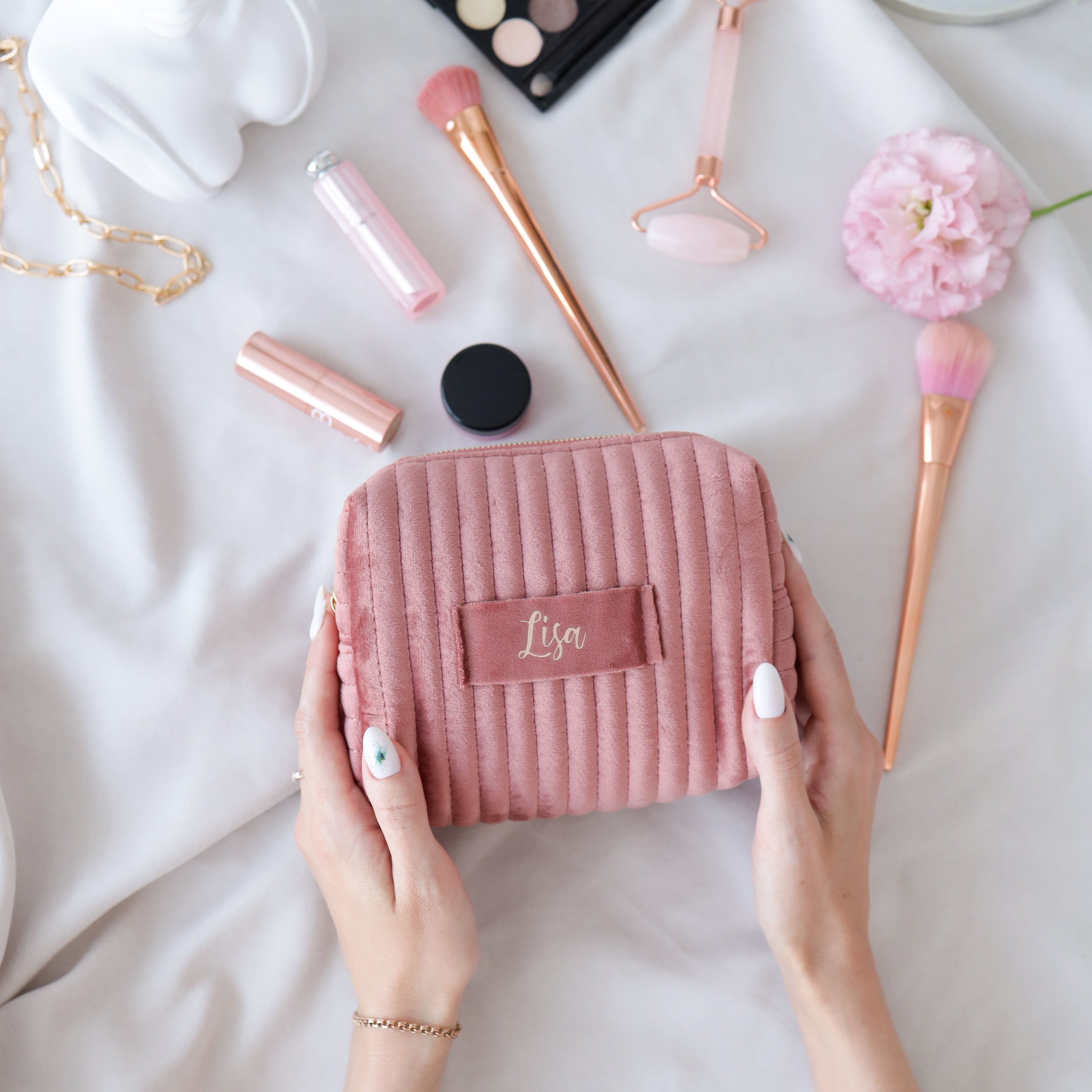 Personalized makeup bag held in hands velvet cosmetic pouch lifestyle