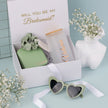 Open bridesmaid gift box with tumbler and items inside