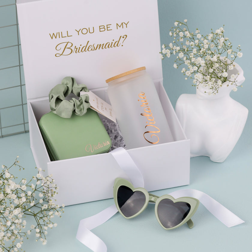 Open bridesmaid gift box with tumbler and items inside