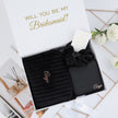 Open bridesmaid gift box with items inside proposal set