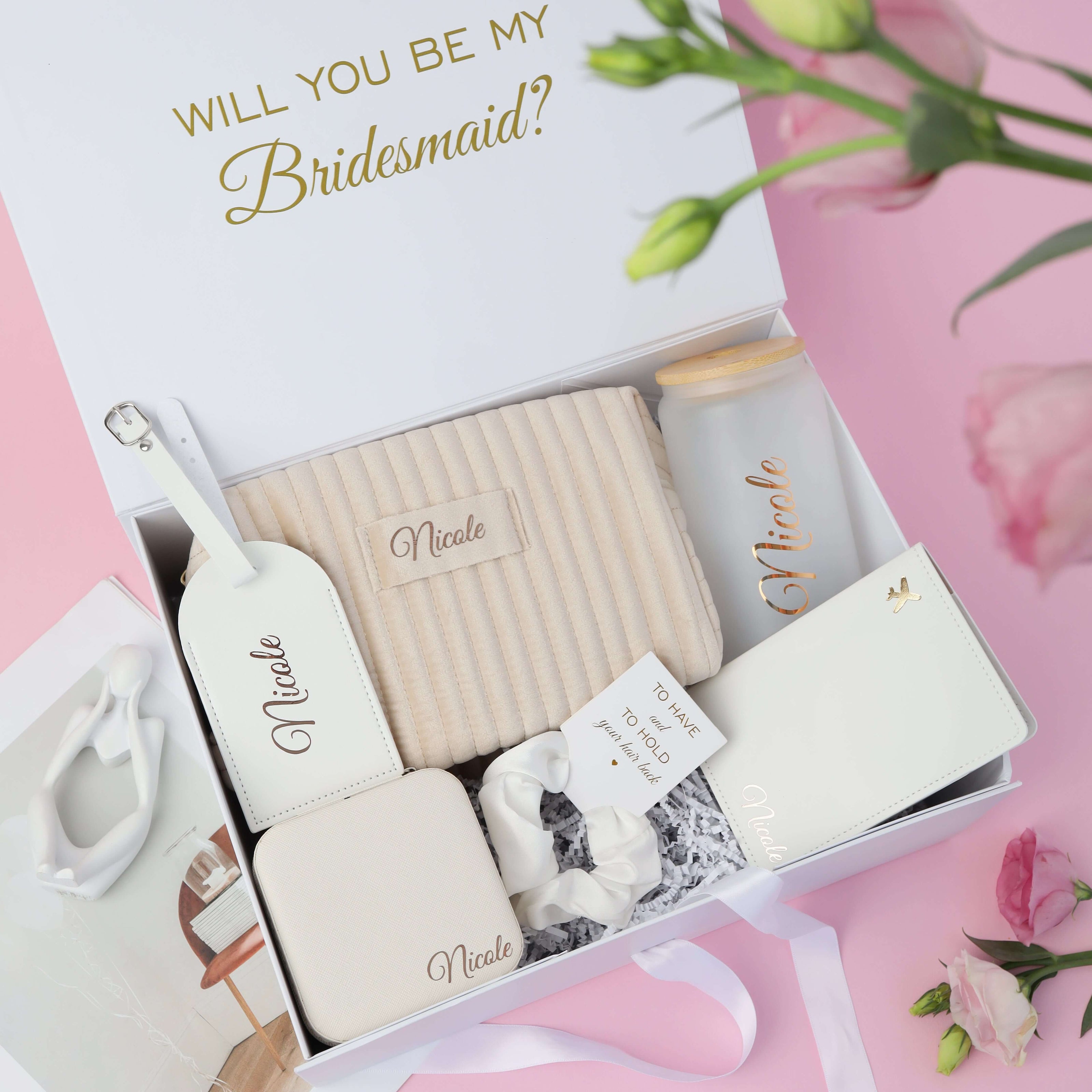 Open bridesmaid gift box with items inside proposal set