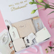 Open bridesmaid gift box with items inside proposal set